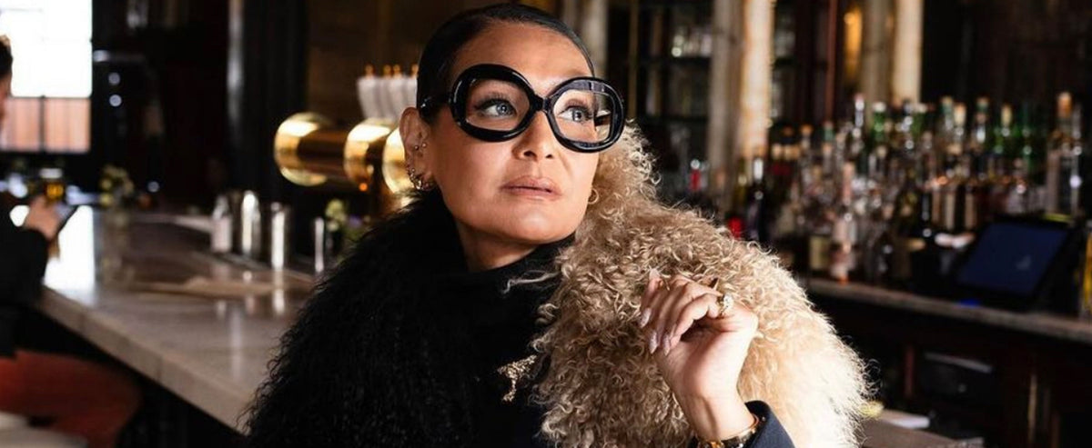 woman wearing a stylish coat and oversized vintage inspired eyeglasses